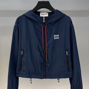 MIUMIU windbreaker, exquisitely tailored with a hood, combining workwear style w
